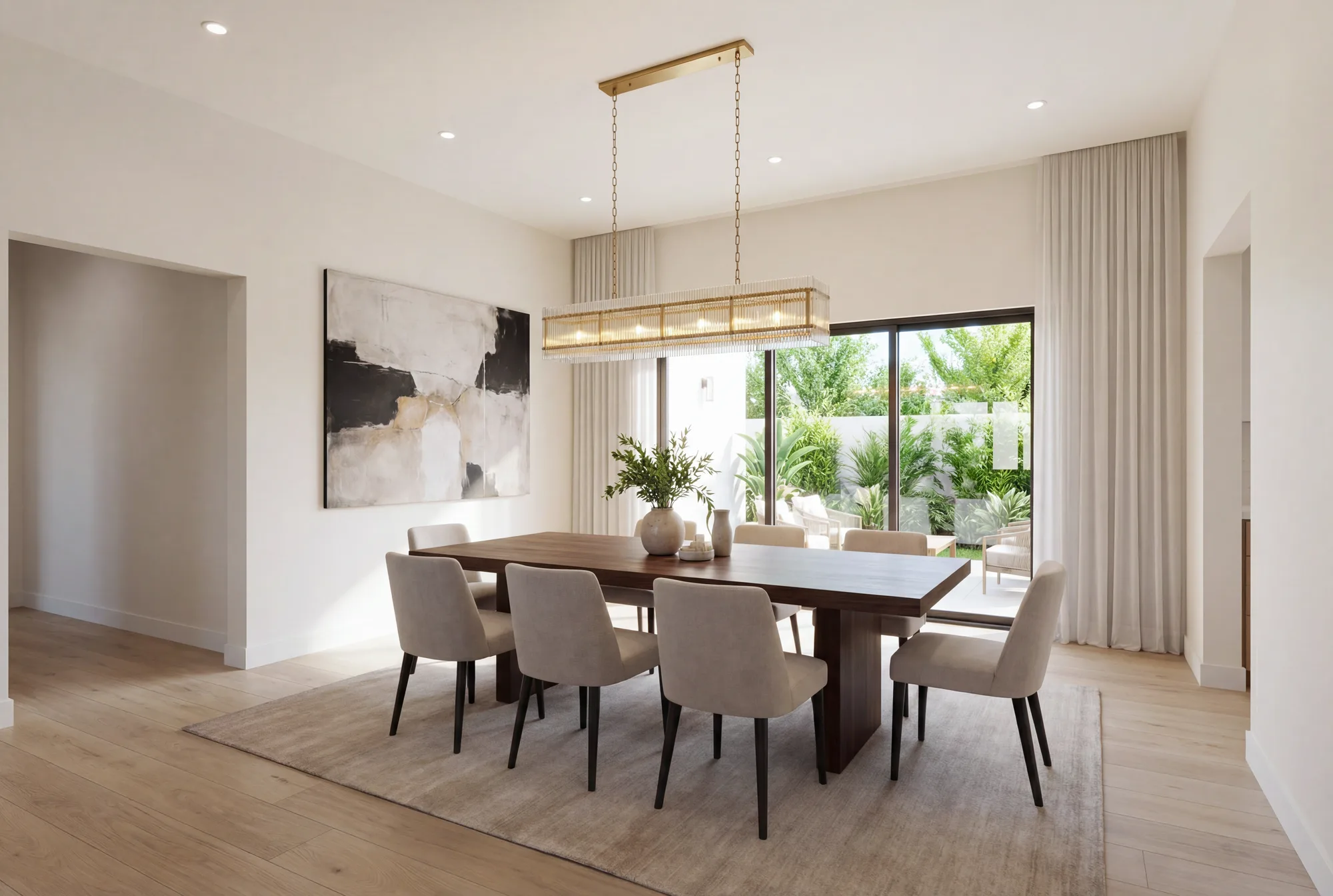 The same room as conceived: a walnut table for eight under a linear brass fixture, opening onto the terrace